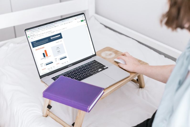 Budgeting - a person using a laptop on a bed