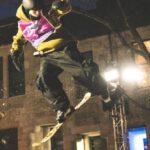 Action Shots - A snowboarder doing a trick on a ramp